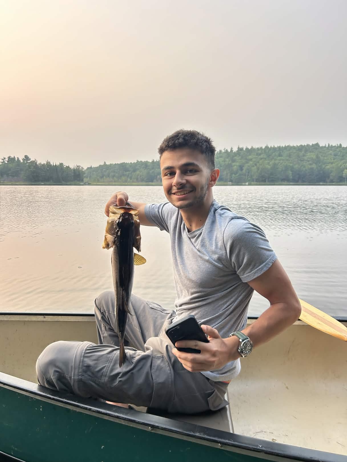 Yazeed fishing in a canoe